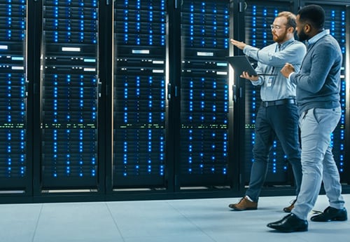 colleagues walk through a data center while discussing the role of data and technology in commercial real estate